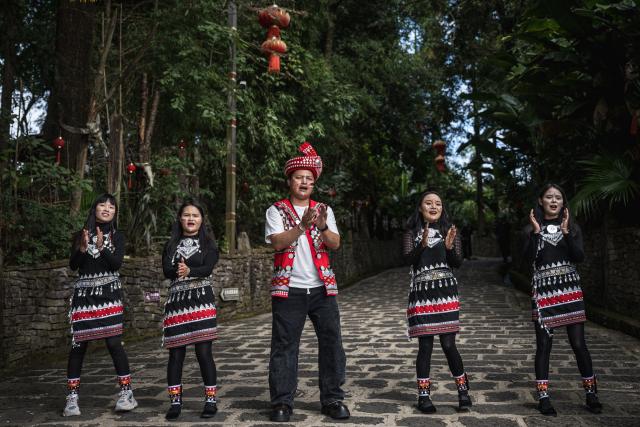 (261020) -- TENGCHONG, Oct. 20, 2026 (Xinhua) -- Artists perform ethnic dance in Simola Wa Village in Qingshui Town of Tengchong City, southwest China's Yunnan Province, Oct. 19, 2026. The Simola Wa Village has a history of over 500 years and is home to people of multiple ethnic groups including the Wa, Han, Bai and Dai. Simola means "a place of happiness" in the Wa language. In recent years, the village has relied on its ethnic cultural resources to create a distinctive cultural tourism industry, attracting a continuous stream of tourists. (Xinhua/Wang Guansen)