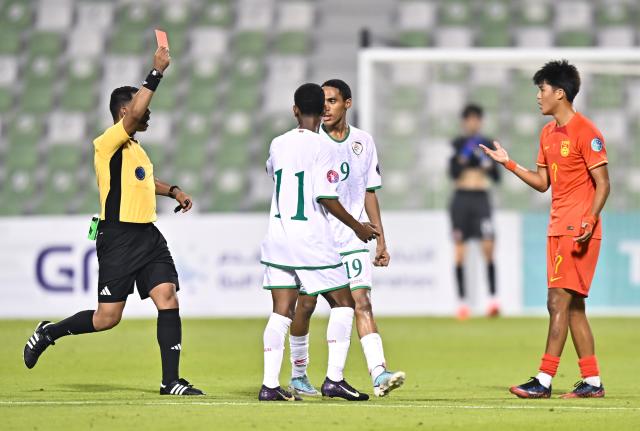 (261020) -- DOHA, Oct. 20, 2026 (Xinhua) -- Referee Abdullah Yahya Zarban (L) shows a red card to Liu Kaiyuan (R) of China during the Gulf Football Federation (GFF) Gulf Cup U-17 Qatar 2026 football match between China and Oman in Doha, Qatar, Oct. 19, 2026. (Photo by Nikku/Xinhua)