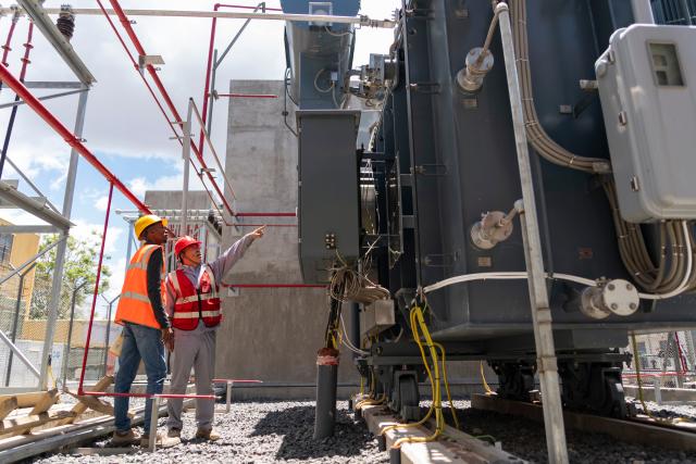 (261020) -- NAKURU, Oct. 20, 2026 (Xinhua) -- Staff members inspect the equipment at Olkaria I Geothermal Power Plant at Hell's Gate National Park in Nakuru County, Kenya, Oct. 19, 2026. Geothermal has consistently contributed 40 to 48 percent of Kenya's electricity in recent years, according to data released from Kenya's Energy and Petroleum Regulatory Authority and the International Energy Agency. Much of this output comes from the Olkaria geothermal field, which is located within Hell's Gate along the Great Rift Valley. (Xinhua/Xie Jianfei)