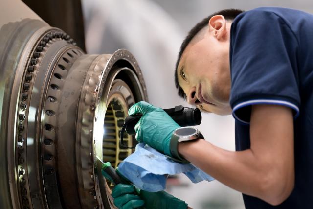 (261020) -- HAIKOU, Oct. 20, 2026 (Xinhua) -- A staff member works at an aero-engine maintenance base of the comprehensive bonded zone of Haikou Airport in Haikou, south China's Hainan Province, Oct. 19, 2026. Leveraging policy benefits and regional advantages, Hainan Free Trade Port (FTP) has vigorously developed its aviation maintenance industry, establishing an international aviation maintenance hub. (Xinhua/Xin Yuewei)