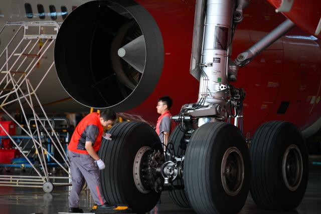 (261020) -- HAIKOU, Oct. 20, 2026 (Xinhua) -- Staff members work at an aero-engine maintenance base of the comprehensive bonded zone of Haikou Airport in Haikou, south China's Hainan Province, Oct. 19, 2026. Leveraging policy benefits and regional advantages, Hainan Free Trade Port (FTP) has vigorously developed its aviation maintenance industry, establishing an international aviation maintenance hub. (Xinhua/Xin Yuewei)