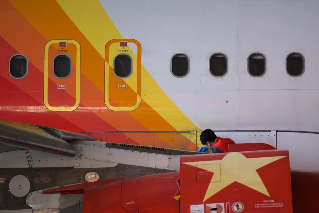 (261020) -- HAIKOU, Oct. 20, 2026 (Xinhua) -- A staff member works at an aero-engine maintenance base of the comprehensive bonded zone of Haikou Airport in Haikou, south China's Hainan Province, Oct. 19, 2026. Leveraging policy benefits and regional advantages, Hainan Free Trade Port (FTP) has vigorously developed its aviation maintenance industry, establishing an international aviation maintenance hub. (Xinhua/Xin Yuewei)