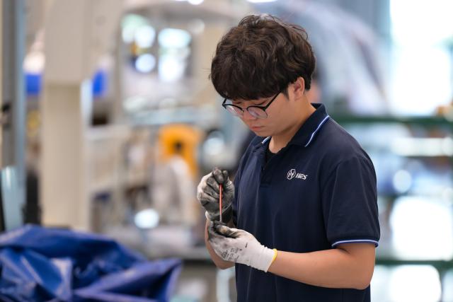 (261020) -- HAIKOU, Oct. 20, 2026 (Xinhua) -- A staff member works at an aero-engine maintenance base of the comprehensive bonded zone of Haikou Airport in Haikou, south China's Hainan Province, Oct. 19, 2026. Leveraging policy benefits and regional advantages, Hainan Free Trade Port (FTP) has vigorously developed its aviation maintenance industry, establishing an international aviation maintenance hub. (Xinhua/Xin Yuewei)