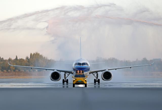 (261020) -- YINCHUAN, Oct. 20, 2026 (Xinhua) -- A C919 aircraft passes through a water gate at the Yinchuan Hedong International Airport in Yinchuan, northwest China's Ningxia Hui Autonomous Region, Oct. 20, 2026. China's homegrown C919 large passenger aircraft landed at the airport at 5:57 p.m. on Tuesday after departing from Changsha in central China's Hunan Province, marking the aircraft's first commercial passenger flight to Yinchuan. (Xinhua/Wang Peng)