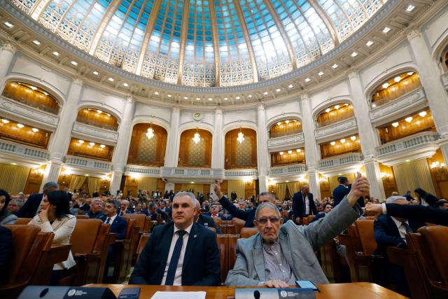 (261020) -- BUCHAREST, Oct. 20, 2026 (Xinhua) -- Members of Romanian parliament attend a confidence vote session for Prime Minister designate Luca Niculescu's government in Bucharest, Romania, Oct. 20, 2026. Romanian parliament approved Luca Niculescu's government on Tuesday, ending a political crisis that has lasted nearly six months.
According to Romania's national news agency Agerpres, of 338 valid votes cast, 280 lawmakers voted in favor of the government's investiture while 58 voted against. (Photo by Cristian Cristel/Xinhua)