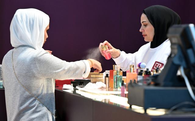 (261020) -- HAWALLI GOVERNORATE, Oct. 20, 2026 (Xinhua) -- A woman samples perfume at a perfume exhibition in Hawalli Governorate, Kuwait, Oct. 20, 2026. A perfume exhibition opened Tuesday at the Kuwait International Fairground in Mishref, Hawalli Governorate, Kuwait, attracting more than 500 exhibitors. Running through Oct. 31, the exhibition features a wide range of products, including perfumes, incense, aromatic oils, as well as beauty and personal care products. (Photo by Asad/Xinhua)