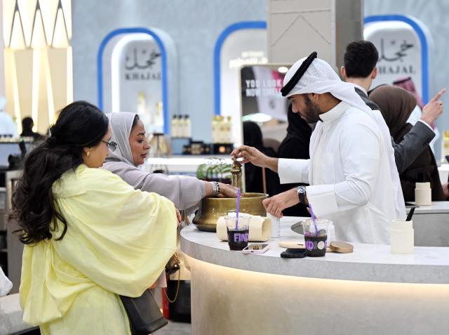 (261020) -- HAWALLI GOVERNORATE, Oct. 20, 2026 (Xinhua) -- Visitors explore a perfume exhibition in Hawalli Governorate, Kuwait, Oct. 20, 2026. A perfume exhibition opened Tuesday at the Kuwait International Fairground in Mishref, Hawalli Governorate, Kuwait, attracting more than 500 exhibitors. Running through Oct. 31, the exhibition features a wide range of products, including perfumes, incense, aromatic oils, as well as beauty and personal care products. (Photo by Asad/Xinhua)