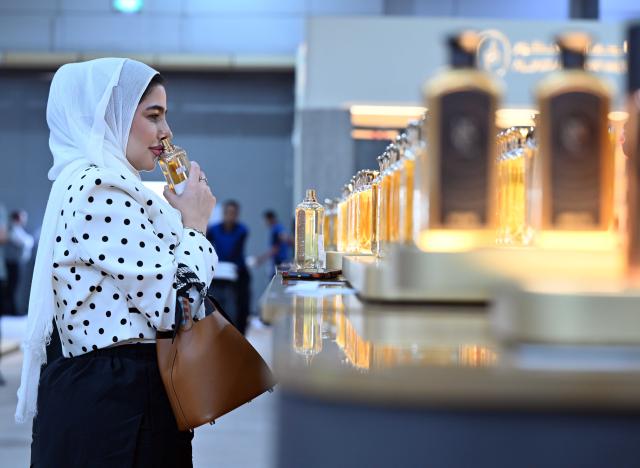 (261020) -- HAWALLI GOVERNORATE, Oct. 20, 2026 (Xinhua) -- A woman samples perfume at a perfume exhibition in Hawalli Governorate, Kuwait, Oct. 20, 2026. A perfume exhibition opened Tuesday at the Kuwait International Fairground in Mishref, Hawalli Governorate, Kuwait, attracting more than 500 exhibitors. Running through Oct. 31, the exhibition features a wide range of products, including perfumes, incense, aromatic oils, as well as beauty and personal care products. (Photo by Asad/Xinhua)