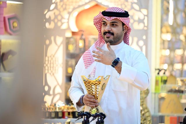 (261020) -- HAWALLI GOVERNORATE, Oct. 20, 2026 (Xinhua) -- A man burns incense at a perfume exhibition in Hawalli Governorate, Kuwait, Oct. 20, 2026. A perfume exhibition opened Tuesday at the Kuwait International Fairground in Mishref, Hawalli Governorate, Kuwait, attracting more than 500 exhibitors. Running through Oct. 31, the exhibition features a wide range of products, including perfumes, incense, aromatic oils, as well as beauty and personal care products. (Photo by Asad/Xinhua)