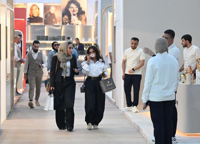 (261020) -- HAWALLI GOVERNORATE, Oct. 20, 2026 (Xinhua) -- Visitors explore a perfume exhibition in Hawalli Governorate, Kuwait, Oct. 20, 2026. A perfume exhibition opened Tuesday at the Kuwait International Fairground in Mishref, Hawalli Governorate, Kuwait, attracting more than 500 exhibitors. Running through Oct. 31, the exhibition features a wide range of products, including perfumes, incense, aromatic oils, as well as beauty and personal care products. (Photo by Asad/Xinhua)