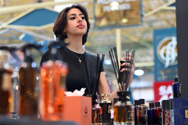 (261020) -- HAWALLI GOVERNORATE, Oct. 20, 2026 (Xinhua) -- A woman samples perfume at a perfume exhibition in Hawalli Governorate, Kuwait, Oct. 20, 2026. A perfume exhibition opened Tuesday at the Kuwait International Fairground in Mishref, Hawalli Governorate, Kuwait, attracting more than 500 exhibitors. Running through Oct. 31, the exhibition features a wide range of products, including perfumes, incense, aromatic oils, as well as beauty and personal care products. (Photo by Asad/Xinhua)