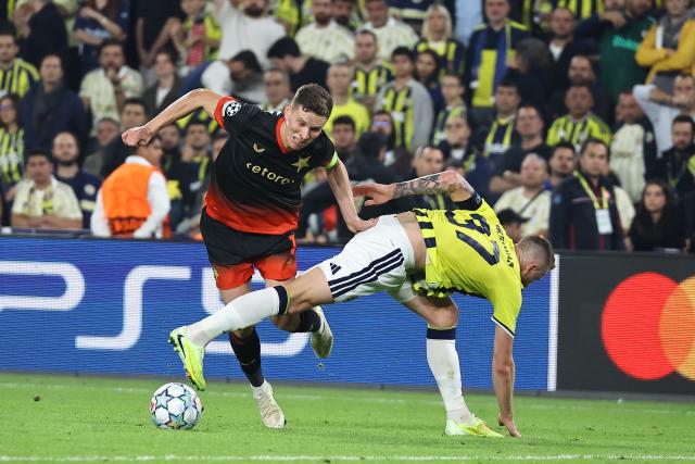 (261021) -- ISTANBUL, Oct. 21, 2026 (Xinhua) -- Milan Skriniar (R) of Fenerbahce vies against Lukas Prodov of SK Slavia Praha during the UEFA Champions League football match between Fenerbahce and SK Slavia Praha in Istanbul, Türkiye, on Oct. 20, 2026. (Photo by Mustafa Kaya/Xinhua)
