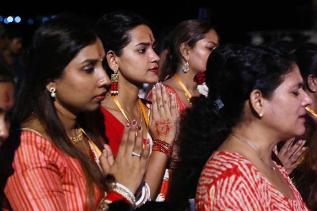 (261021) -- YANGON, Oct. 21, 2026 (Xinhua) -- Devotees pray during the Durga Puja, one of the largest Hindu festivals, in Yangon, Myanmar, Oct. 20, 2026. (Xinhua/Myo Kyaw Soe)