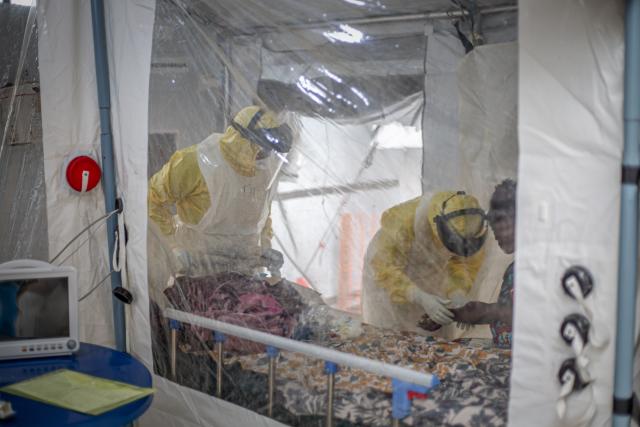 (261021) -- KINSHASA, Oct. 21, 2026 (Xinhua) -- Medical workers check an infected patient at an Ebola treatment center in Bunia, capital of Ituri Province in the Democratic Republic of the Congo (DRC), on Oct. 18, 2026.
  The Africa Centers for Disease Control and Prevention (Africa CDC) has called for greater global solidarity and international support to contain the rapidly expanding Bundibugyo Ebola outbreak.
  TO GO WITH "Africa CDC urges greater global solidarity to contain Ebola as Nigeria confirms 1st case" (Xinhua)