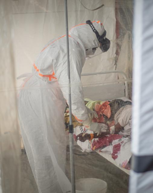 (261021) -- KINSHASA, Oct. 21, 2026 (Xinhua) -- A medical worker treats an infected patient at an Ebola treatment center in Bunia, capital of Ituri Province in the Democratic Republic of the Congo (DRC), on Oct. 18, 2026.
  The Africa Centers for Disease Control and Prevention (Africa CDC) has called for greater global solidarity and international support to contain the rapidly expanding Bundibugyo Ebola outbreak.
  TO GO WITH "Africa CDC urges greater global solidarity to contain Ebola as Nigeria confirms 1st case" (Xinhua)
