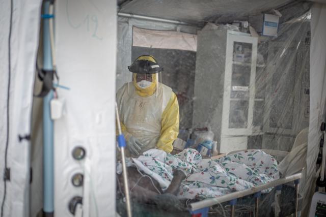 (261021) -- KINSHASA, Oct. 21, 2026 (Xinhua) -- A medical worker checks an infected patient at an Ebola treatment center in Bunia, capital of Ituri Province in the Democratic Republic of the Congo (DRC), on Oct. 18, 2026.
  The Africa Centers for Disease Control and Prevention (Africa CDC) has called for greater global solidarity and international support to contain the rapidly expanding Bundibugyo Ebola outbreak.
  TO GO WITH "Africa CDC urges greater global solidarity to contain Ebola as Nigeria confirms 1st case" (Xinhua)