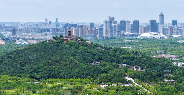(261021) -- BEIJING, Oct. 21, 2026 (Xinhua) -- A drone photo taken on July 10, 2026 shows the scenery of the Langshan national forest park and its surrounding region in Nantong, east China's Jiangsu Province. (Xinhua/Ji Chunpeng)