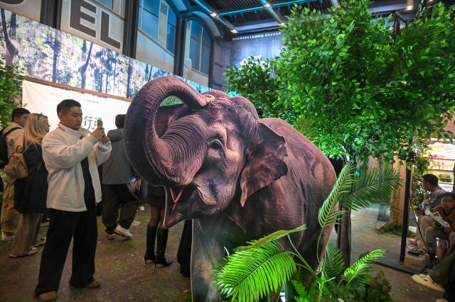 (261021) -- BEIJING, Oct. 21, 2026 (Xinhua) -- An audience takes photos of an elephant model at a cinema in Beijing, capital of China, Oct. 21, 2026. The premiere of the documentary film "The Elephant Odyssey", which follows the improbable journey of the wandering Asian elephants in southwest China's Yunnan Province that captivated viewers around the world, was held in Beijing on Wednesday. 
In March 2020, the elephants left a forest nature reserve in Xishuangbanna Dai Autonomous Prefecture, Yunnan Province, and trekked about 500 km northwards to the provincial capital Kunming, arriving in June 2021. They have since headed south again, arriving safely back at the nature reserve.
The film is a collaborative effort between film institutions from China, Canada and Singapore, representing a valuable attempt to tell the story of China's ecological conservation. (Xinhua/Jin Liangkuai)