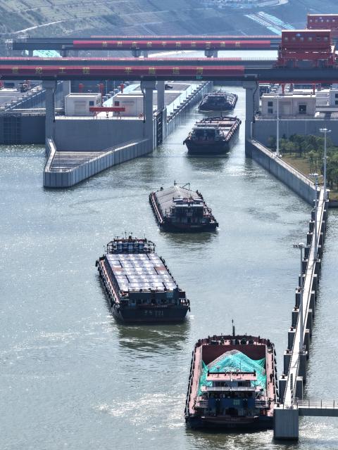 (261021) -- QINZHOU, Oct. 21, 2026 (Xinhua) -- An aerial drone photo taken on Oct. 21, 2026 shows cargo vessels passing through the Madao hub on the Pinglu Canal in south China's Guangxi Zhuang Autonomous Region. Cargo throughput of the Pinglu Canal has surpassed 1 million tonnes since its opening to navigation on Sept. 16.
  The 134.2-kilometer canal runs from Nanning, capital of south China's Guangxi Zhuang Autonomous Region, to the Beibu Gulf, the closest maritime outlet for much of southwest China.
  The canal stretches along the New International Land-Sea Trade Corridor, a strategic trade route connecting China's inland regions with ASEAN and other global markets. It is the first river-to-sea canal project planned and coordinated at the national level since the founding of the People's Republic of China in 1949. (Xinhua/Zhou Hua)