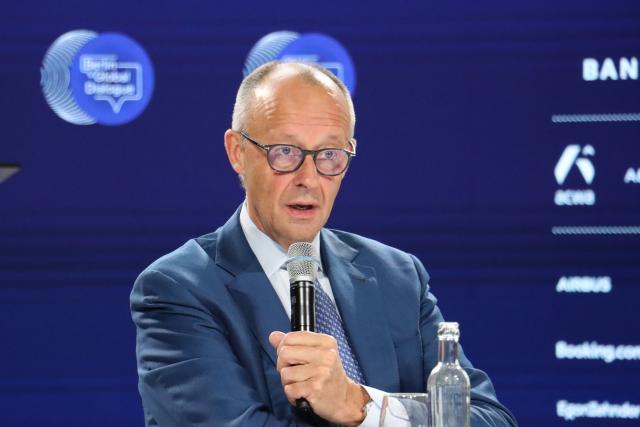 (261021) -- BERLIN, Oct. 21, 2026 (Xinhua) -- German Chancellor Friedrich Merz speaks during the Berlin Global Dialogue in Berlin, Germany, Oct. 21, 2026. German Chancellor Friedrich Merz said on Wednesday that the European Union (EU) needs to protect its industries against unfair competition while keeping its markets open and avoiding a trade war. (Xinhua/Li Hanlin)