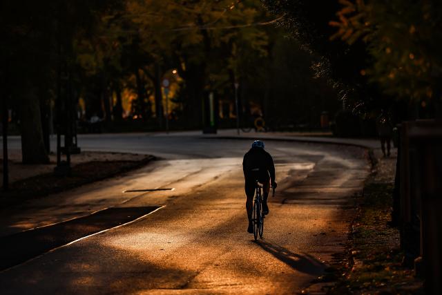 (261021) -- BUDAPEST, Oct. 21, 2026 (Xinhua) -- A person rides a bike under autumn sunset glow in the City Park in Budapest, Hungary, Oct. 21, 2026. (Photo by David Balogh/Xinhua)