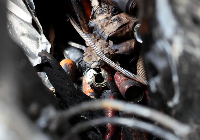(261021) -- PARIS, Oct. 21, 2026 (Xinhua) -- Cans are seen inside a vehicle destroyed by fire during the earlier demonstration on a street in Paris, France, Oct. 21, 2026. The French government has vowed to do everything within its power to prevent violence at fresh social demonstrations announced for Saturday, after riots around the country caused widespread destruction and thousands of arrests on Oct. 17. (Xinhua/Wu Huiwo)