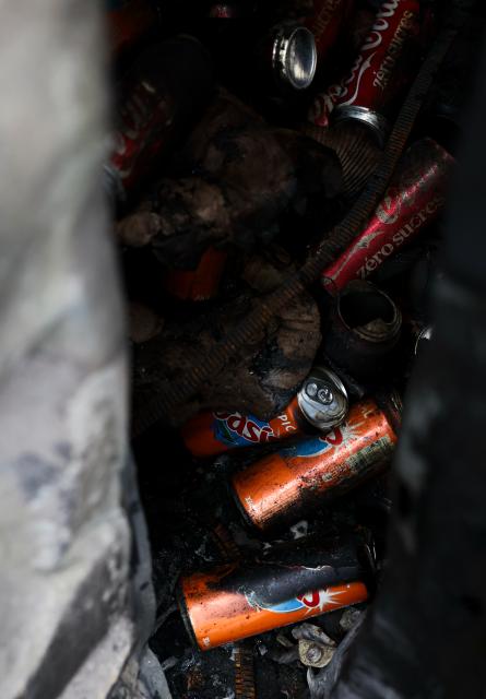 (261021) -- PARIS, Oct. 21, 2026 (Xinhua) -- Cans are seen inside a vehicle destroyed by fire during the earlier demonstration on a street in Paris, France, Oct. 21, 2026. The French government has vowed to do everything within its power to prevent violence at fresh social demonstrations announced for Saturday, after riots around the country caused widespread destruction and thousands of arrests on Oct. 17. (Xinhua/Wu Huiwo)