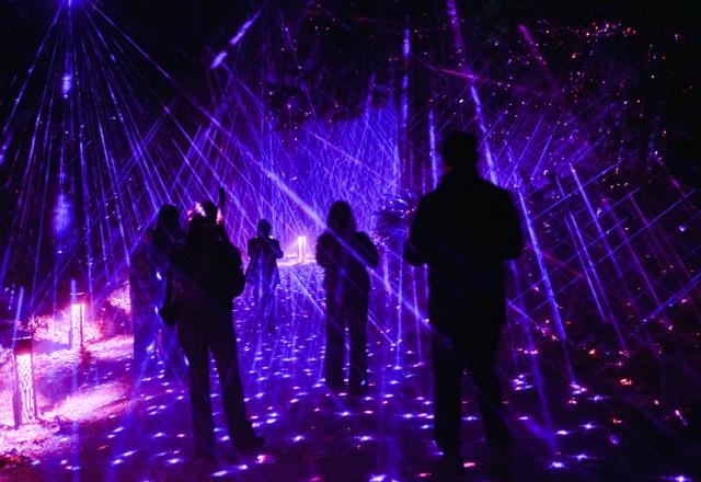 (261022) -- VANCOUVER, Oct. 22, 2026 (Xinhua) -- Visitors view illuminated installations during a preview of Astra Lumina at Stanley Park in Vancouver, British Columbia, Canada, on Oct. 21, 2026. Astra Lumina, an immersive outdoor night walk, will make its Canadian debut at Stanley Park on Thursday. The approximately 1.6-kilometer trail features nine themed zones where colorful light installations, projections and soundscapes transform the forest into a star-inspired nighttime experience. 
   The event runs from Oct. 22 to Dec. 31. (Photo by Liang Sen/Xinhua)