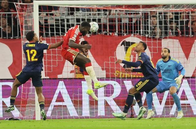 (261022) -- MUNICH, Oct. 22, 2026 (Xinhua) -- Dayot Upamecano (2nd L) of Bayern Munich heads for the ball during the UEFA Champions League match between Bayern Munich and Arsenal in Munich, Germany, on Oct. 21, 2026. (Photo by Philippe Ruiz/Xinhua)