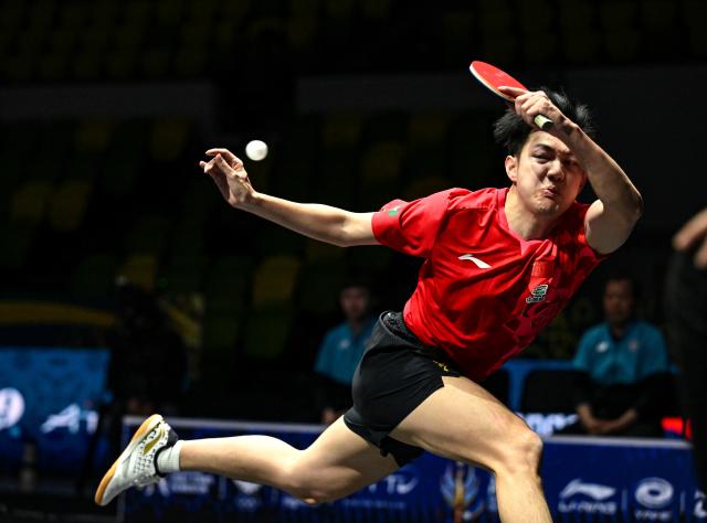 (261022) -- TASHKENT, Oct. 22, 2026 (Xinhua) -- Huang Youzheng of China hits a return during the men's teams semifinals against Kuo Guan-Hong of Chinese Taipei at the 29th ITTF-Asian Table Tennis Championships in Tashkent, Uzbekistan, Oct. 22, 2026. (Xinhua/Feng Kaihua)