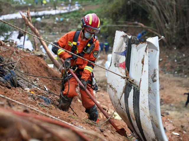 (261022) -- LIUZHOU, Oct. 22, 2026 (Xinhua) -- Jiang Shengqiang works at the crash site of the China Eastern Airlines flight MU5735 in Tengxian County, south China's Guangxi Zhuang Autonomous Region, March 25, 2022. TO GO WITH "Profile: Where courage ends, skill begins -- the making of a rope rescuer" (Xinhua)