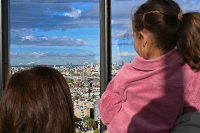 (261022) -- LONDON, Oct. 22, 2026 (Xinhua) -- Tourists get a panoramic view of central London from the top of the 109-meter north-west chimney of Battersea Power Station in London, Britain, Oct. 22, 2026. Located on the south bank of the River Thames in London, Battersea Power Station was built in two main phases between 1929 and 1955. At its peak, the coal-fired power station supplied about one-fifth of London's electricity, powering important buildings including Buckingham Palace and the Houses of Parliament.
The building, known for its four white chimneys, stood derelict for decades after electricity generation ceased in 1983. Following restoration and redevelopment, the former industrial landmark reopened to the public in 2022 as a mixed-use complex featuring shops, restaurants, offices, homes and leisure facilities. (Xinhua/Li Mangmang)