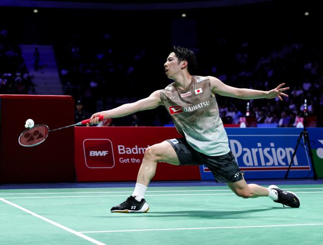 (261023) -- PARIS, Oct. 23, 2026 (Xinhua) -- Watanabe Koki of Japan hits a return during the men's singles 1/8 final match between Moh. Zaki Ubaidillah of Indonesia and Watanabe Koki of Japan at the French Open badminton tournament in Paris, France, Oct. 22, 2026. (Xinhua/Wu Huiwo)