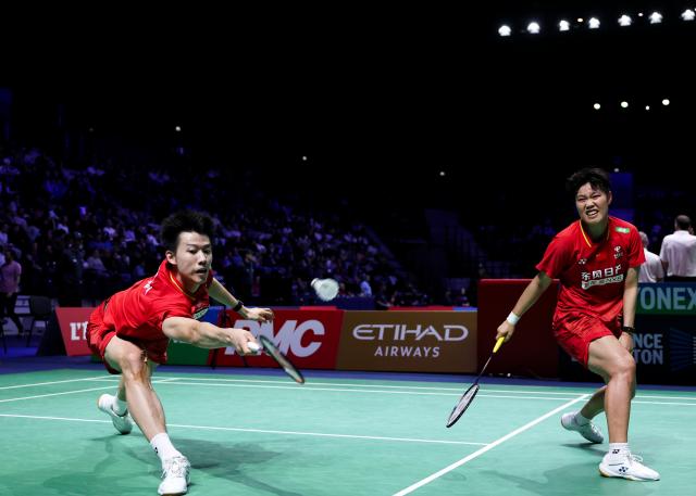 (261023) -- PARIS, Oct. 23, 2026 (Xinhua) -- Feng Yanzhe (L)/Huang Dongping of China compete during the mixed doubles 1/8 final match between Feng Yanzhe/Huang Dongping of China and Ruben Garcia/Lucia Rodriguez of Spain at the French Open badminton tournament in Paris, France, Oct. 22, 2026. (Xinhua/Wu Huiwo)