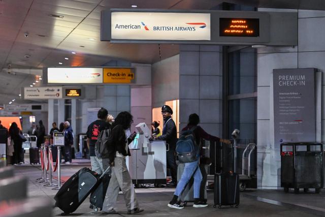 (261023) -- NEW YORK, Oct. 23, 2026 (Xinhua) -- Travelers walk with their luggage at John F. Kennedy International Airport (JFK) in New York City, the United States, Oct. 22, 2026. As major U.S. airlines reported their third-quarter (Q3) operating results, rising fuel costs put pressure on their profit margins despite strong travel demand.
   TO GO WITH "High fuel costs squeeze major U.S. airlines' profits despite strong revenues" (Photo by Ziyu Julian Zhu/Xinhua)