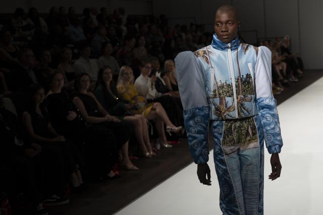 (261023) -- JOHANNESBURG, Oct. 23, 2026 (Xinhua) -- A model presents a creation from the Autumn/Winter 2027 collections during the South African Fashion Week in Johannesburg, South Africa, Oct. 22, 2026. (Photo by Ihsaan Haffejee/Xinhua)