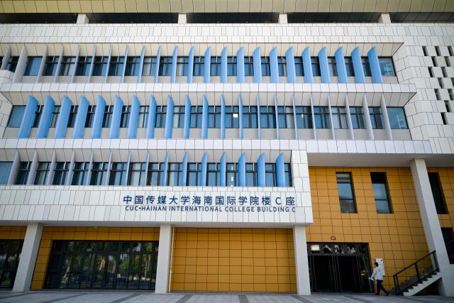 (261023) -- LINGSHUI, Oct. 23, 2026 (Xinhua) -- A man enters a building in the Hainan International College of the Communication University of China (CUC) at Lingshui Li'an International Education Innovation Pilot Zone in Lingshui Li Autonomous County, south China's Hainan Province, Oct. 22, 2026.
  As China's highland of educational opening up and innovation, Lingshui Li'an International Education Innovation Pilot Zone started construction in 2020. So far, over 30 renowned colleges and universities from home and abroad have settled in the pilot zone.
  The pilot zone is promoting as well as encouraging overseas high-level universities to run independent schools in the zone. It adopts an innovative model that all the universities have their own buildings, but share public facilities including the library, sports venues and public teaching buildings. (Xinhua/Xin Yuewei)