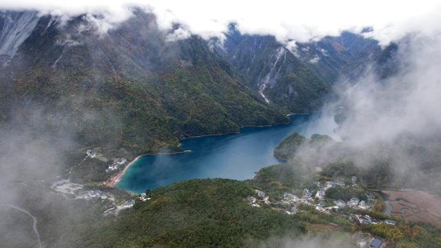 (261023) -- WENXIAN, Oct. 23, 2026 (Xinhua) -- An aerial drone photo taken on Oct. 22, 2026 shows the autumn scenery of Tianchi lake national forest park in Wenxian County, northwest China's Gansu Province. In late autumn, Tianchi lake national forest park is adorned with richly colored foliage. (Xinhua/Chen Bin)