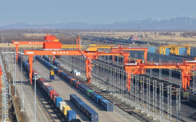 (261023) -- HARBIN, Oct. 23, 2026 (Xinhua) -- A drone photo taken on Oct. 23, 2026 shows transshipment operations at the transshipment yard at Tongjiang North Railway Station in Tongjiang, northeast China's Heilongjiang Province. According to China Railway Harbin Group, a total of 6,024 China-Europe freight train trips have been made via the eastern corridor of the China-Europe freight train service so far this year, up 40.3 percent year on year. (Photo by Wu Yunan/Xinhua)