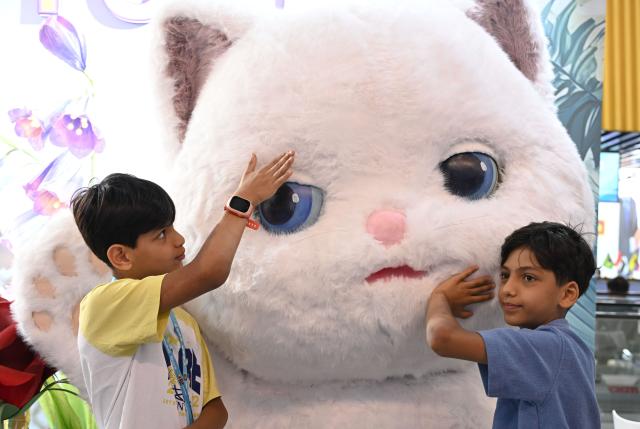 (261023) -- GUANGZHOU, Oct. 23, 2026 (Xinhua) -- Children interact with a decorative installation during the second phase of the 140th Canton Fair in Guangzhou, south China's Guangdong Province, Oct. 23, 2026. The second phase of the 140th China Import and Export Fair, also known as the Canton Fair, kicked off here on Friday. Themed "Quality Home Life," the second phase covered 515,000 square meters, with over 10,000 participating enterprises. (Xinhua/Deng Hua)