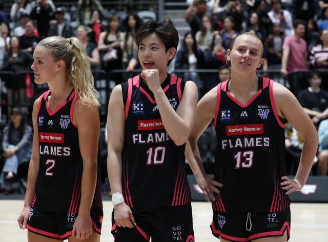 (261023) -- SYDNEY, Oct. 23, 2026 (Xinhua) -- Isabelle Morgan, Yang Shuyu and Peggy Schell of Sydney Flames react after the Women's National Basketball League (WNBL) basketball match between Sydney Flames and UC Capitals in Sydney, Australia, Oct. 23, 2026. (Xinhua/Gong Bing)