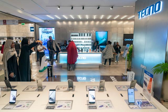 (261023) -- NAIROBI, Oct. 23, 2026 (Xinhua) -- Customers try smartphones at a Tecno store in Nairobi, Kenya, Aug. 25, 2026. TO GO WITH "Feature: Chinese smartphones help narrow digital divide in Africa" (Xinhua/Xie Jianfei)