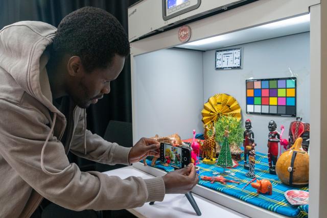 (261023) -- NAIROBI, Oct. 23, 2026 (Xinhua) -- A staff member tests the camera performance of a smartphone at the Tecno office in Nairobi, Kenya, Aug. 25, 2026. TO GO WITH "Feature: Chinese smartphones help narrow digital divide in Africa" (Xinhua/Xie Jianfei)