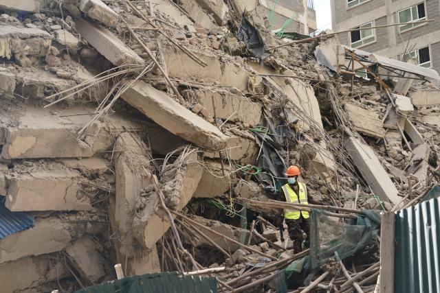 (261023) -- NAIROBI, Oct. 23, 2026 (Xinhua) -- A rescuer works at the site of a building collapse accident in Eastleigh, Nairobi, Kenya, Oct. 23, 2026. Several people are feared trapped after an 18-story building under construction collapsed Friday afternoon in Eastleigh, a high-density commercial and residential suburb of Nairobi, the Kenyan capital. (Xinhua/Xie Jianfei)