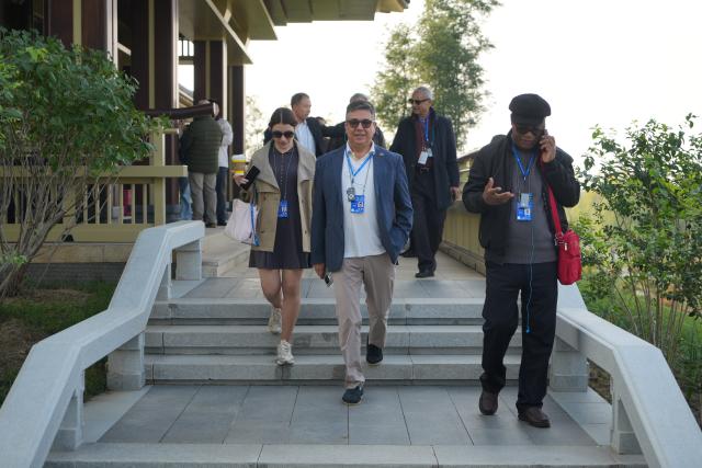 (261023) -- XIONG'AN, Oct. 23, 2026 (Xinhua) -- Participants of the 2026 Global Governance Forum (Xiong'an) visit the construction site of the start-up zone of Xiong'an New Area in north China's Hebei Province, Oct. 23, 2026. The 2026 Global Governance Forum (Xiong'an) kicked off here on Friday and will last till Sunday. Participants from various countries and regions visited a smart-city science and innovation center and the construction site of the start-up zone of Xiong'an New Area ahead of the forum. (Xinhua/Su Kaiyang)