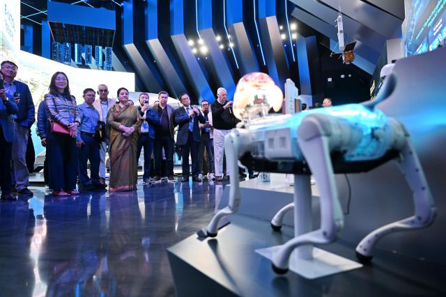 (261023) -- XIONG'AN, Oct. 23, 2026 (Xinhua) -- Participants of the 2026 Global Governance Forum (Xiong'an) visit a smart-city science and innovation center in Xiong'an New Area, north China's Hebei Province, Oct. 23, 2026. The 2026 Global Governance Forum (Xiong'an) kicked off here on Friday and will last till Sunday. Participants from various countries and regions visited a smart-city science and innovation center and the construction site of the start-up zone of Xiong'an New Area ahead of the forum. (Xinhua/Mu Yu)