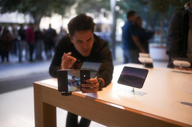 (261023) -- MEXICO CITY, Oct. 23, 2026 (Xinhua) -- An influencer makes a video with the iPhone Duo at an Apple Store in Mexico City, Mexico, Oct. 23, 2026. Apple's first foldable smartphone, the iPhone Duo, officially went on sale on Oct. 23, 2026, in the first wave of markets worldwide, including Mexico. (Xinhua/Li Muzi)