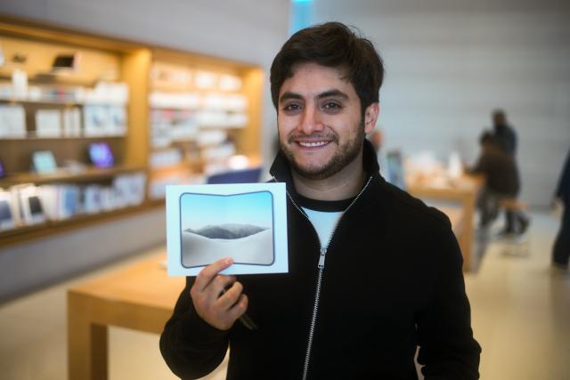 (261023) -- MEXICO CITY, Oct. 23, 2026 (Xinhua) -- A man displays an iPhone Duo at an Apple Store in Mexico City, Mexico, Oct. 23, 2026. Apple's first foldable smartphone, the iPhone Duo, officially went on sale on Oct. 23, 2026, in the first wave of markets worldwide, including Mexico. (Xinhua/Li Muzi)