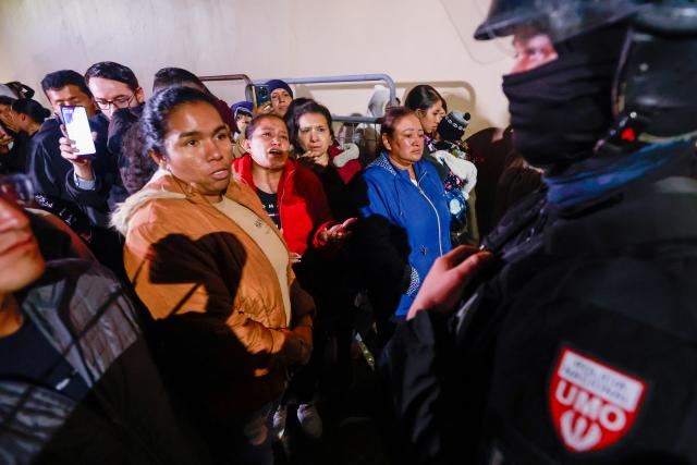 (261023) -- QUITO, Oct. 23, 2026 (Xinhua) -- Photo taken on Oct. 22, 2026 shows relatives of inmates asking a police officer for information outside El Inca prison, in northern Quito, capital of Ecuador. Eight inmates were killed Thursday in two separate riots at prisons in the Andean provinces of Cotopaxi and Pichincha in Ecuador, the National Service for Comprehensive Care for Adults Deprived of Liberty and Adolescent Offenders (SNAI) said. (Photo by Ricardo Landeta/Xinhua)
