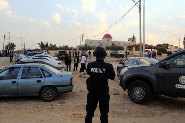 (261023) -- KARAK, Oct. 23, 2026 (Xinhua) -- A police officer stands guard outside the church where a shooting attack occurred during a funeral in Jordan's southern governorate of Karak, Jordan, Oct. 23, 2026. Seven people were killed and 34 others injured in a shooting attack during a funeral in Jordan's southern governorate of Karak, the Jordanian Public Security Directorate said Friday. (Photo by Mohammad Abu Ghosh/Xinhua)